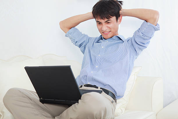 istock businessman sitting on a sofa scratching his head 184346114
