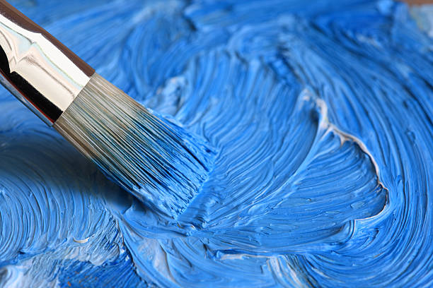 istock Paintbrush with blue oil paint on a classical palette 184346176