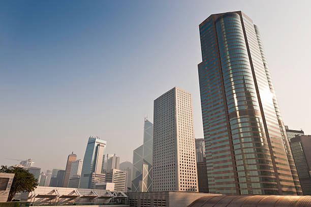 Futuristic cityscape skyscrapers gleaming Hong Kong China "Steel and glass corporate towers gleaming in the low sun under clear blue skies rising from the crowded city blocks of Hong Kong's Central District, China. ProPhoto RGB profile for maximum color fidelity and gamut." the bank of china tower stock pictures, royalty-free photos & images