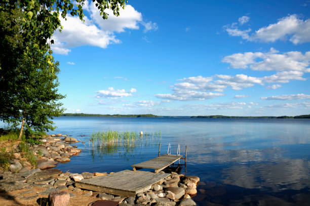 Lake Saimaa in summer. Lake Saimaa (Finland) in summer. Beautiful cluodskape reflecting on the lake surface. Pretty blue sky. saimaa stock pictures, royalty-free photos & images