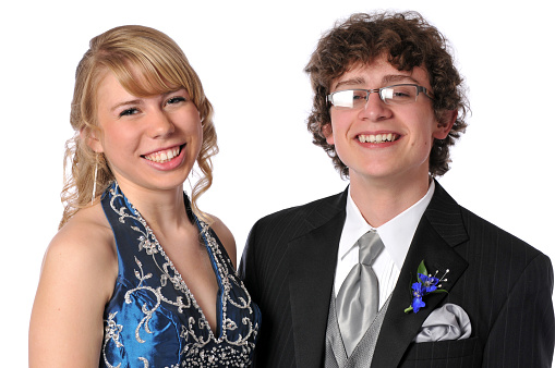 horizontal image of smiling teenage couple ready for the prom.