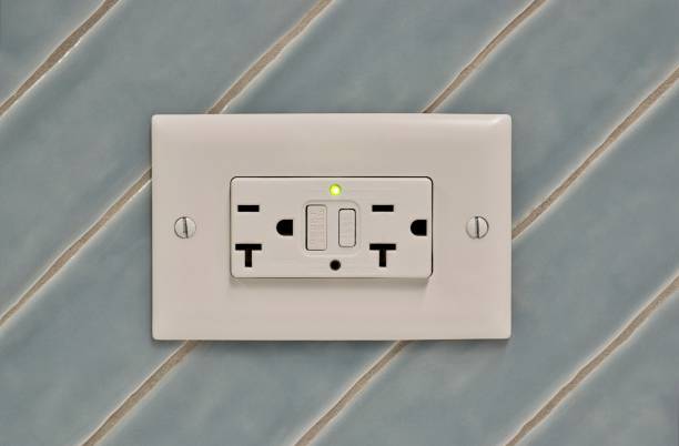 istock Twin power outlet duplex socket on a tiled wall, USA NEMA 5-15 connection. 1843466763