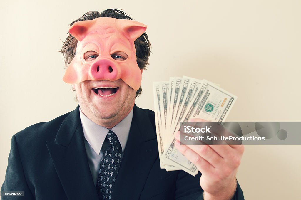 ビジネスの男性の豚マネー - 手に持つのロイヤリティフリーストックフォト