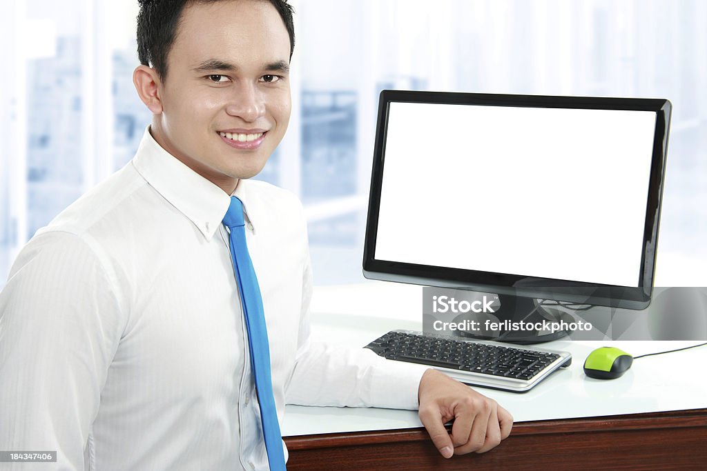 young business man working Portrait of a young business man smiling with computer in the offiice Adult Stock Photo