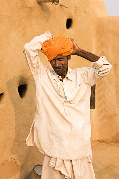 istock Indian man fixing his turban. Rajasthan. India. 184347670