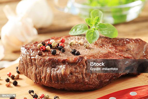 Roasted Steak On A Cutting Board Stock Photo - Download Image Now - Basil, Beef, Cooking