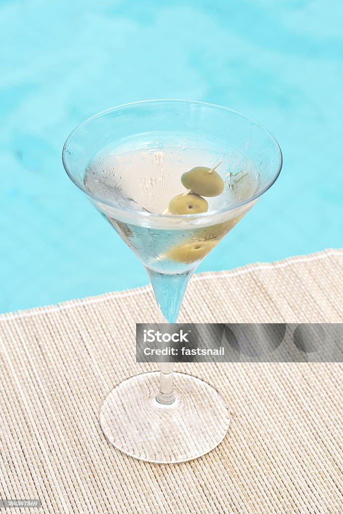 Classic dry martini cocktail near waterpool on the mat Olive - Fruit Stock Photo