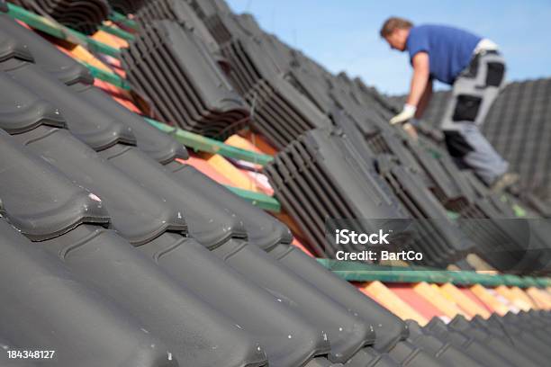 Roofer Is Working Hard On A Roof Stock Photo - Download Image Now - Roofer, Rooftop, Roof Tile