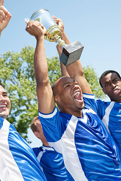 istock Happy Soccer Team Holding Up Victory Trophy 184348338