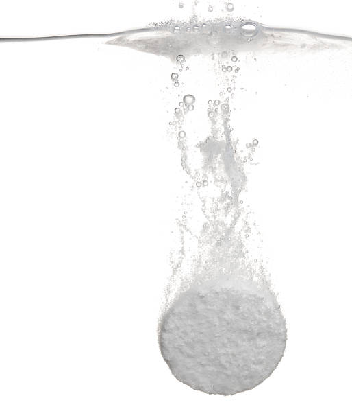 istock Tablet fizzing in water 184348636