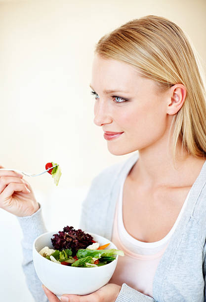 istock Healthy woman eating salad 184350176