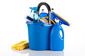 A blue bucket containing cleaning items and yellow gloves