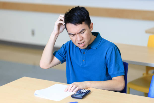 istock Teen student getting stuck and confused while doing a test 1843504388