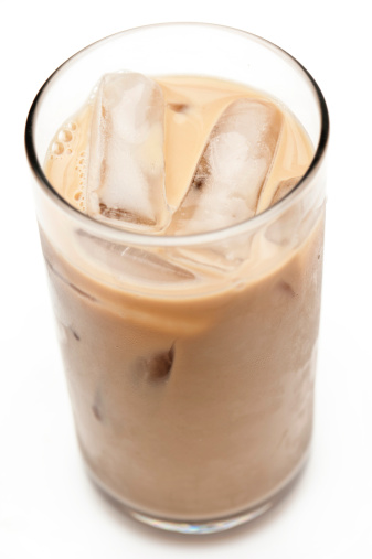 Glass containing Iced Cappuccino Coffee (could be protein milk also) on white background