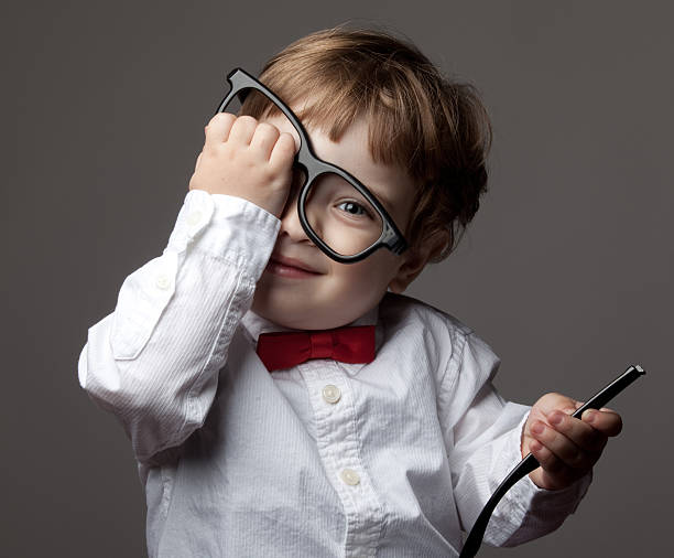 istock Little boy with bow tie trying big glasses 184351091