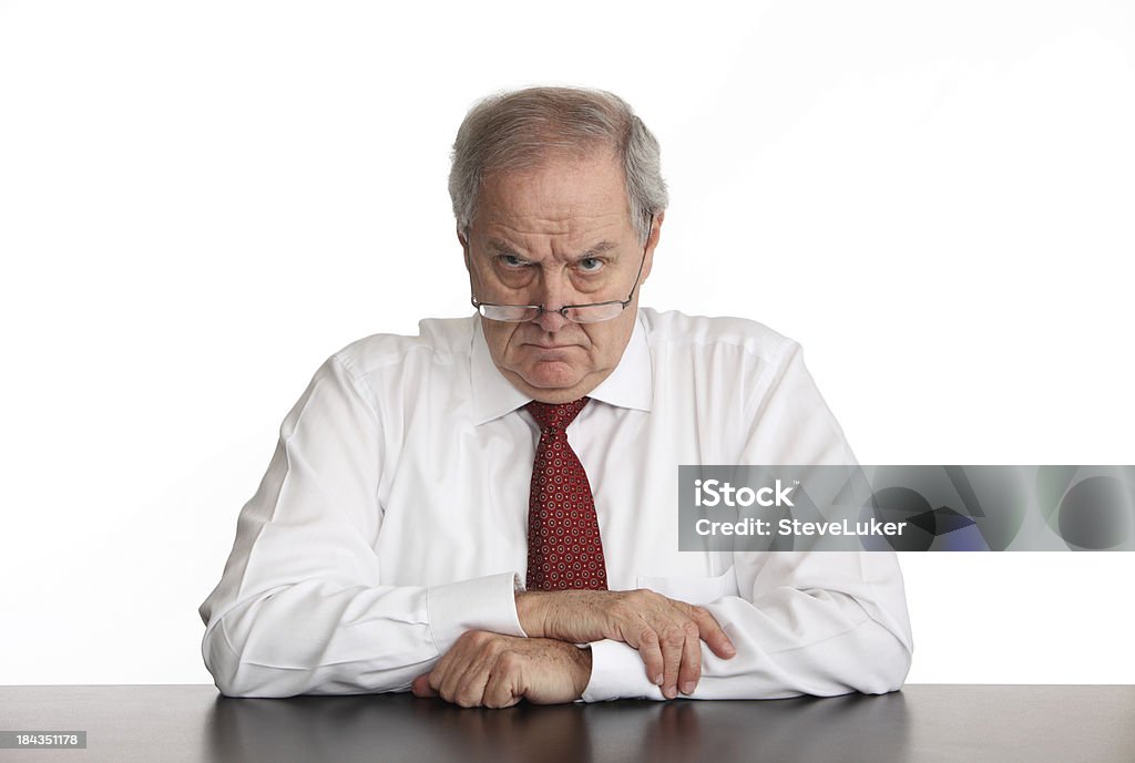 Angry Manager Angry businessman sitting at his desk. Displeased Stock Photo