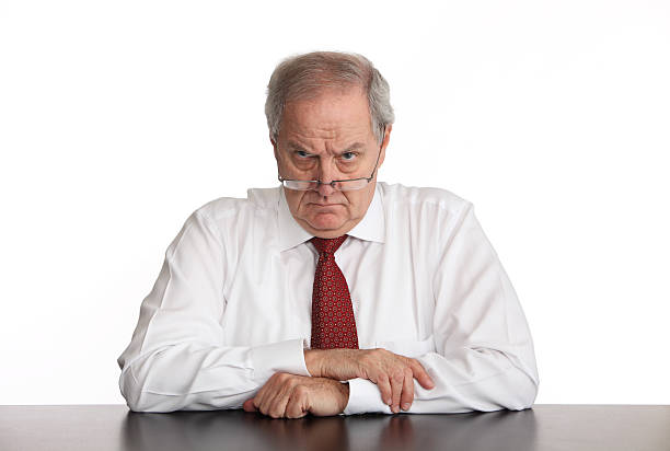 Angry Manager Angry businessman sitting at his desk. displeased stock pictures, royalty-free photos & images