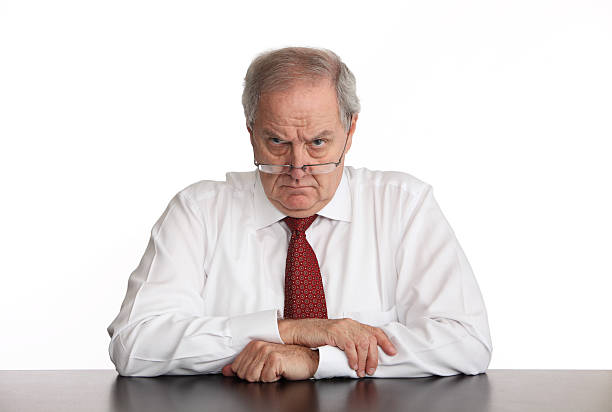 Angry Manager Angry businessman sitting at his desk. overseeing stock pictures, royalty-free photos & images