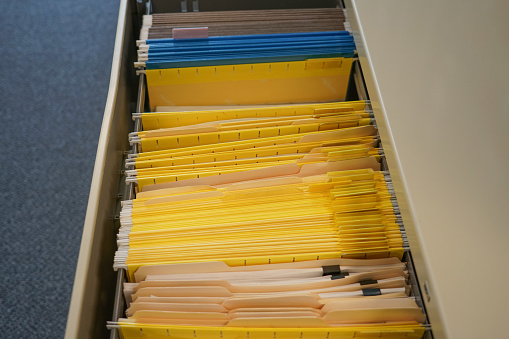 Files document of hanging folders in a drawer, work office document storage