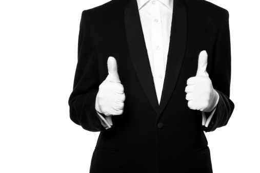 Butler/waiter thumbs up isolated on a white background