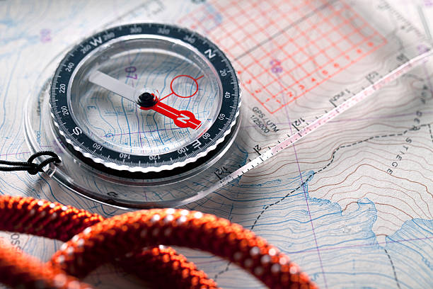 Compass on topographic maps. Compass on topographic maps with rope climbing.Similar photographs from my portfolio: orienteering stock pictures, royalty-free photos & images