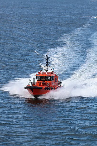 istock Fast orange and black pilot boat in Sweden blue sea 184351684