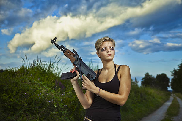 istock Young woman with AK47 184351831