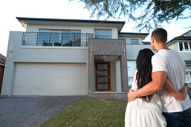 istock Couple admiring a new house. 184351885