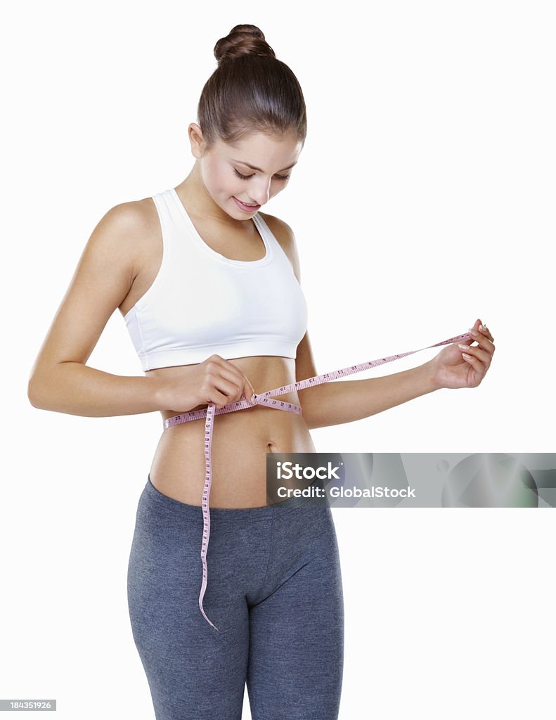 Woman measuring perfect waist Portrait of attractive young woman measuring perfect waist on white background 20-29 Years Stock Photo