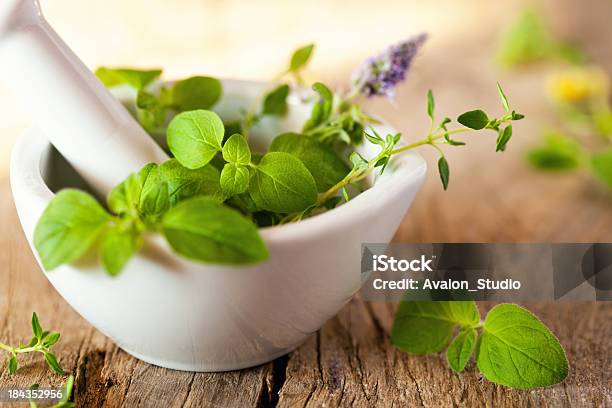 Green Herbs In A White Mortar On A Wooden Plank Stock Photo - Download Image Now - Alternative Medicine, Herbal Medicine, Leaf
