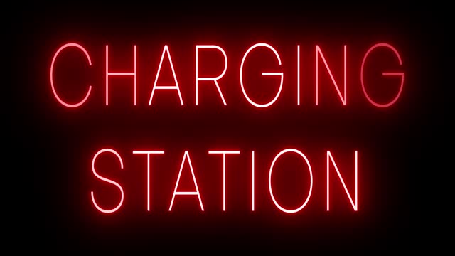 Glowing and blinking neon sign for CHARGING STATION