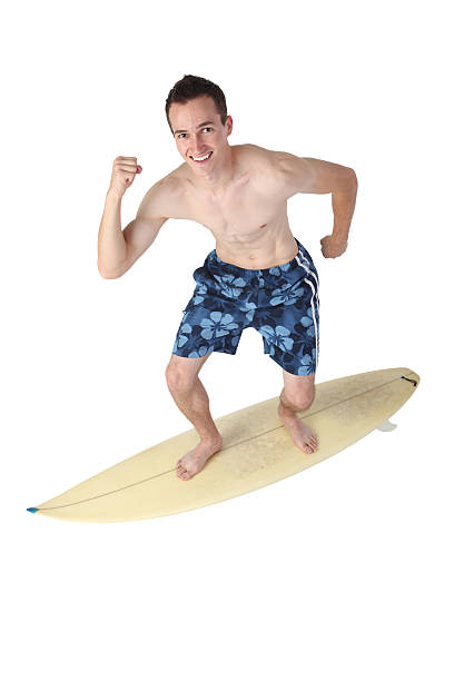 man surfing на surboard - swimming shorts surfing male full length стоковые фото и изображения