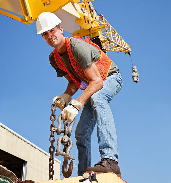 istock Worker on crane holding steel hook 184354221