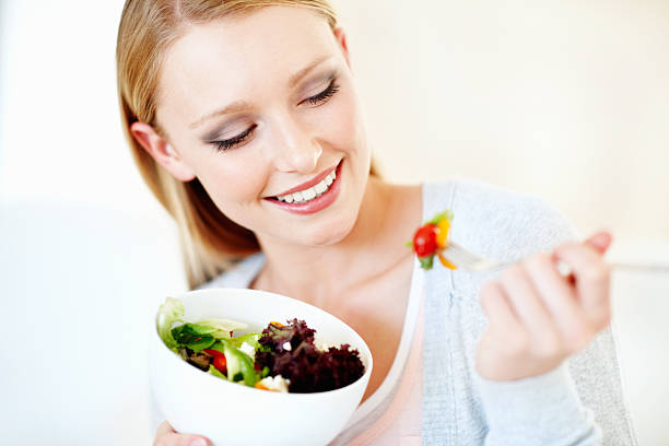 istock Beautiful woman eating salad 184354263
