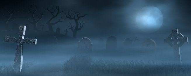 A foggy graveyard at full moon.