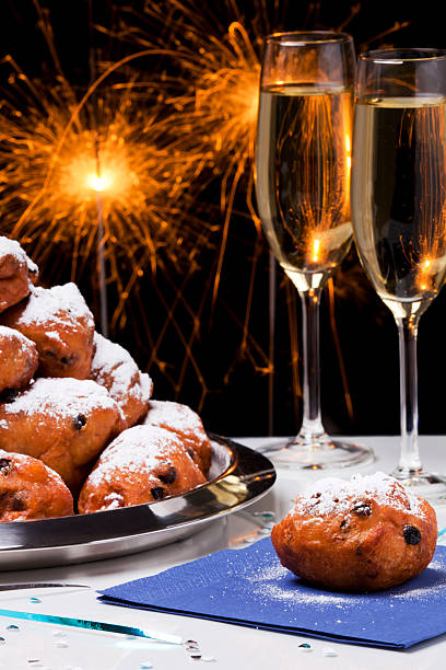 dutch new year's eve with oliebollen, a traditional pastry - oliebollen stockfoto's en -beelden