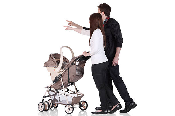 istock Couple with a baby stroller 184354642