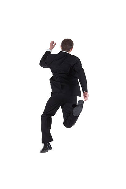 istock Rear view of a businessman runnng 184354648