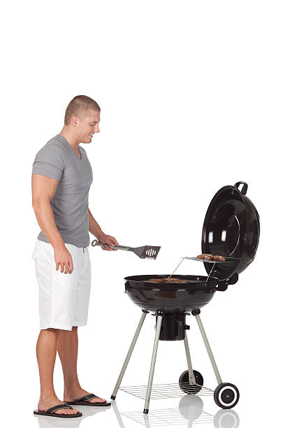 istock Man preparing food in a barbecue grill 184354771