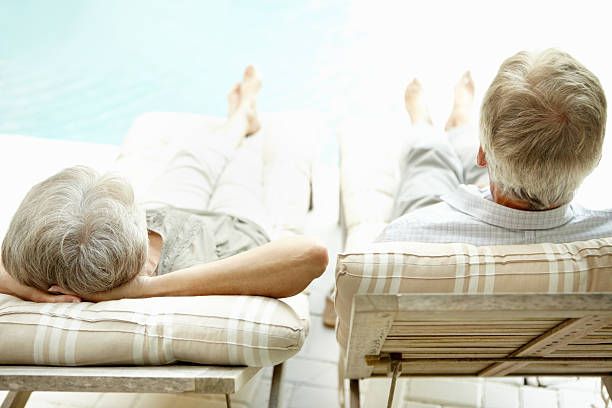istock Relaxed senior couple on lounge chairs 184355045