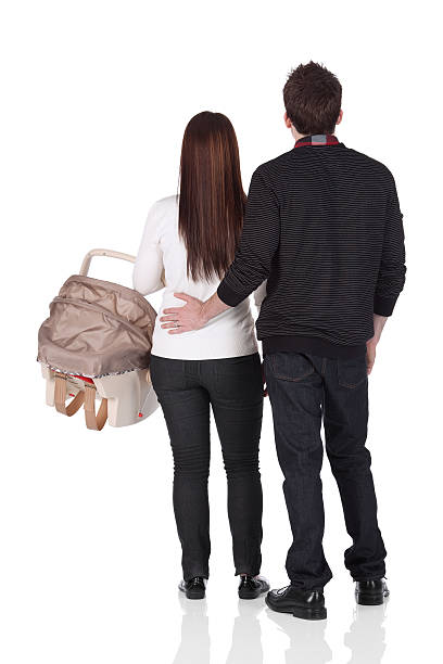 istock Couple standing with a baby seat 184355214