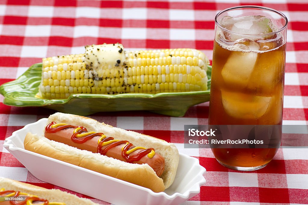 Hotdog and corn on the cob Corn on the cob with iced tea.Corn on the cob with iced tea. Butter Stock Photo