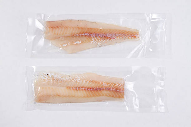 Packaged Fish Collection of packaged fish in shrink wrap. vacuum packed stock pictures, royalty-free photos & images