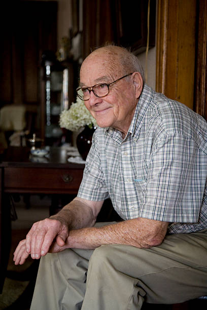 istock Senior Citizen sitting on a chair, smiling 184356871