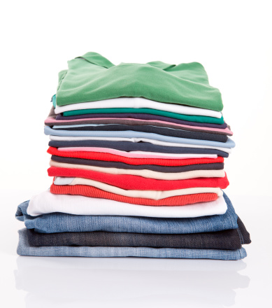 Pile of colorful clothes over white background.