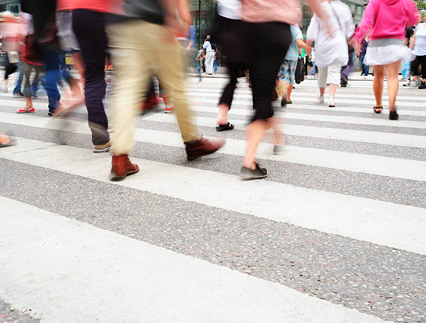 istock Motion blurred pedestrians on major zebra crossing 184357120