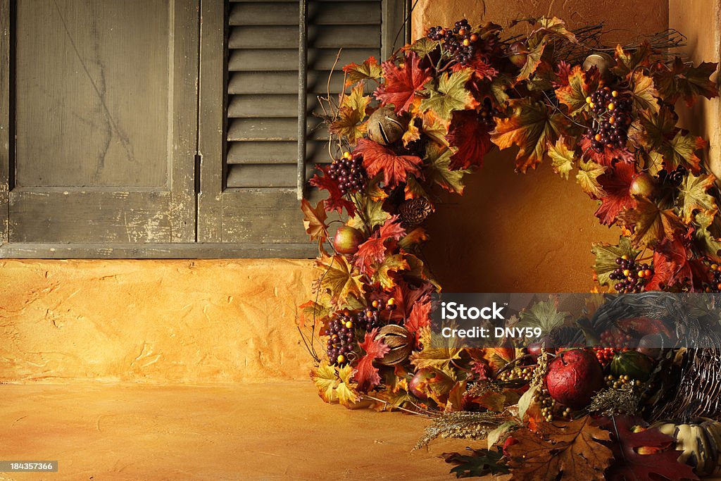 Fall Wreath A fall wreath and a cornucopia resting on in a rustic setting.To see more of my Thanksgiving images click on link below: Thanksgiving - Holiday Stock Photo