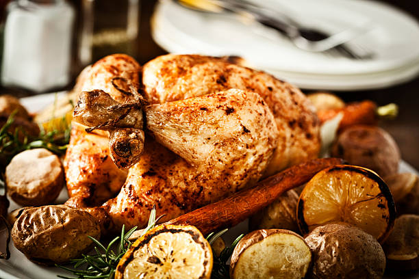 istock Roasted Chicken Dinner with Lemon, Potatoes, Carrots and Rosemary 184358104
