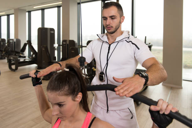 Fit Couple Together Training Back On Machine stock photo