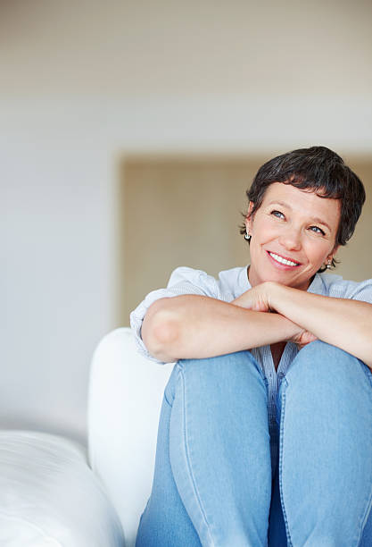 istock Thoughtful woman relaxing at home 184358297